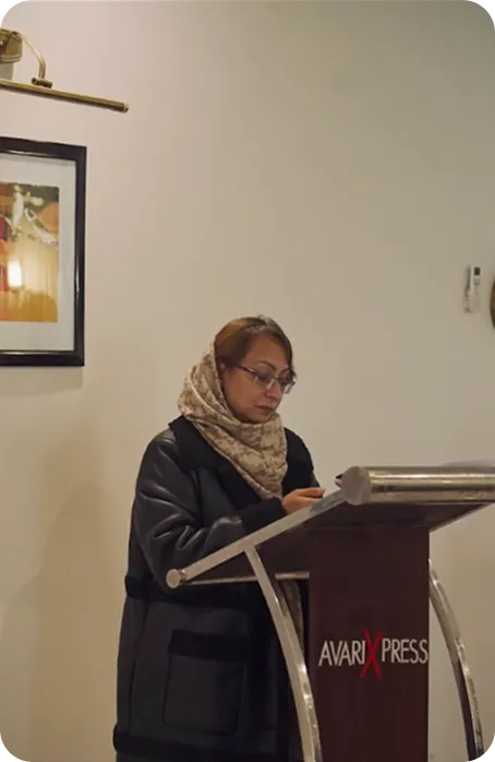 Speaker addressing an audience indoors